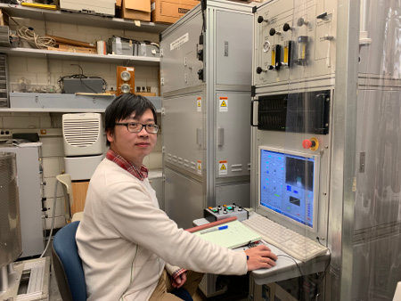 photo of Bin Gao working on a laser-heated floating zone furnace (Feb. 2019)