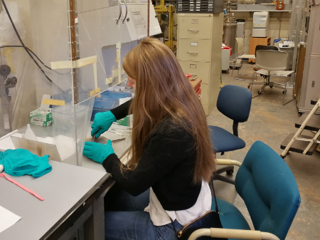 photo of Christina Breth Nielsen preparing samples for floating zone growth (Mar 2019)